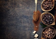 Top view of three different varieties of coffee beans on dark vintage background